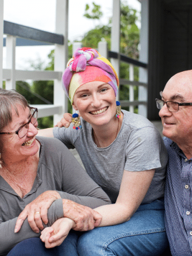 Female cancer patient and her supportive parents